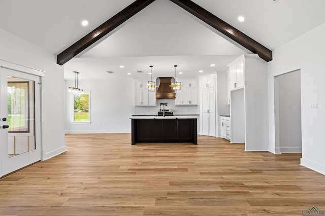 kitchen with white cabinets, recessed lighting, an inviting chandelier, and premium range hood