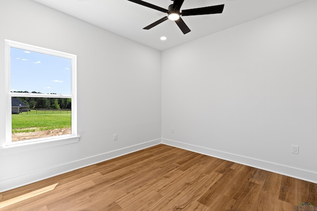 empty room with baseboards, ceiling fan, recessed lighting, and wood finished floors