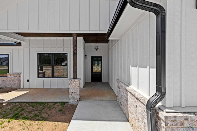 view of exterior entry featuring board and batten siding