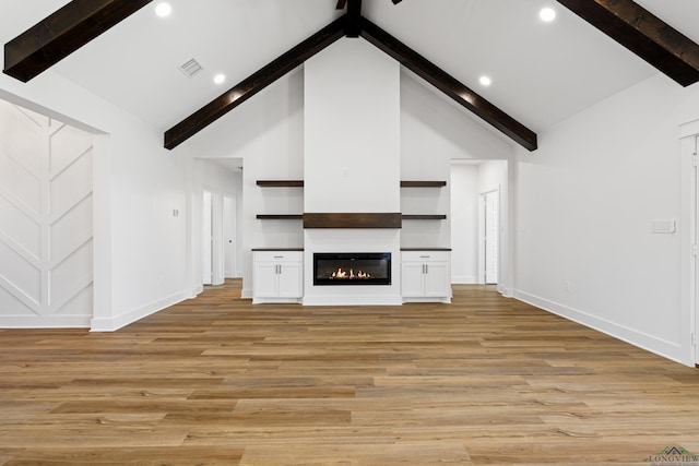 unfurnished living room featuring baseboards, beamed ceiling, light wood-style flooring, and visible vents