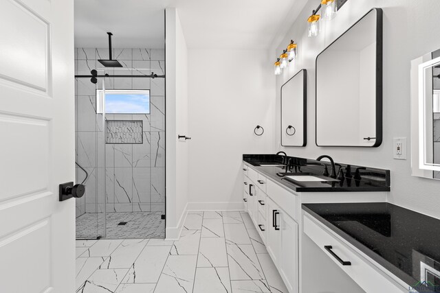 bathroom featuring baseboards, a sink, marble finish floor, and a stall shower