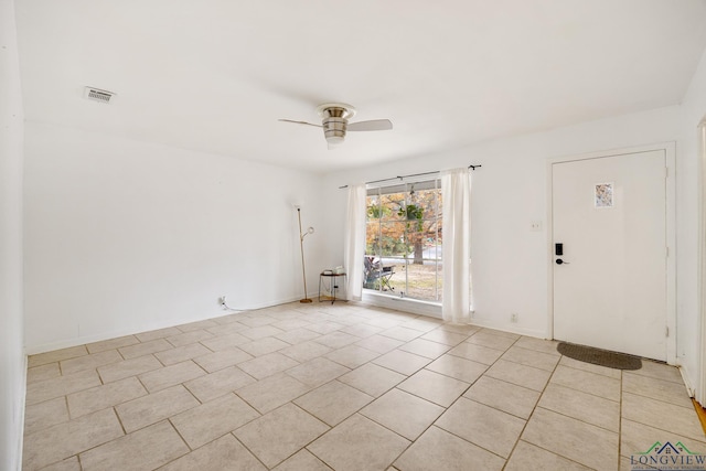 spare room featuring light tile patterned floors and ceiling fan