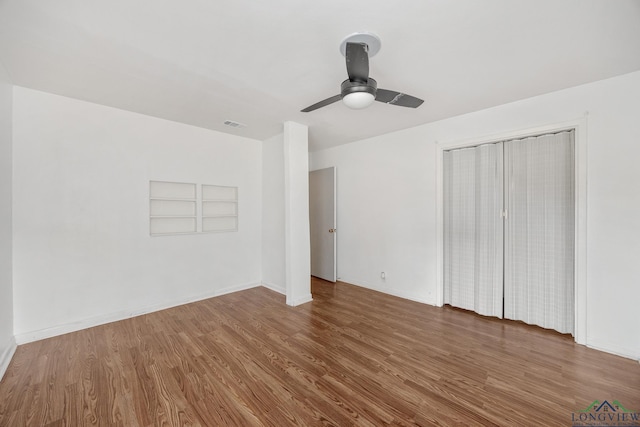 unfurnished bedroom with hardwood / wood-style floors, a closet, and ceiling fan