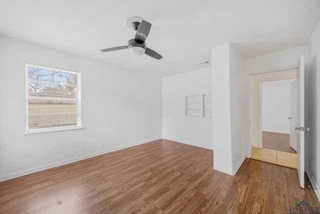 spare room with hardwood / wood-style flooring and ceiling fan