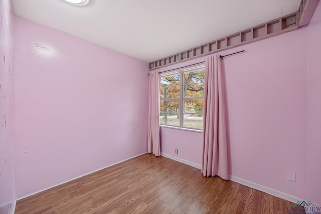 spare room with light wood-type flooring