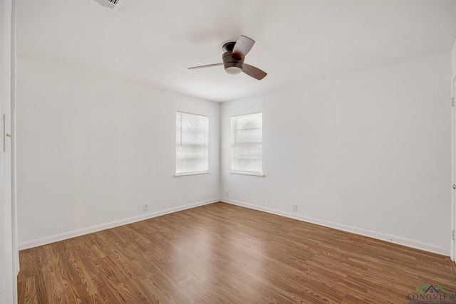 spare room with ceiling fan and hardwood / wood-style floors