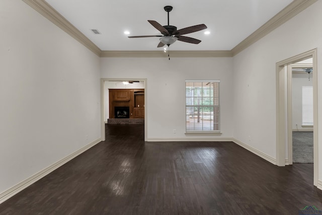 unfurnished living room with wood finished floors, a ceiling fan, visible vents, a brick fireplace, and crown molding