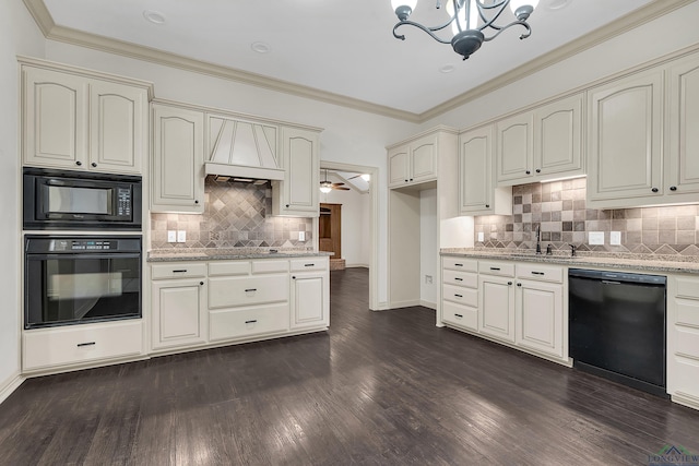 kitchen featuring cream cabinetry, crown molding, black appliances, and light stone countertops