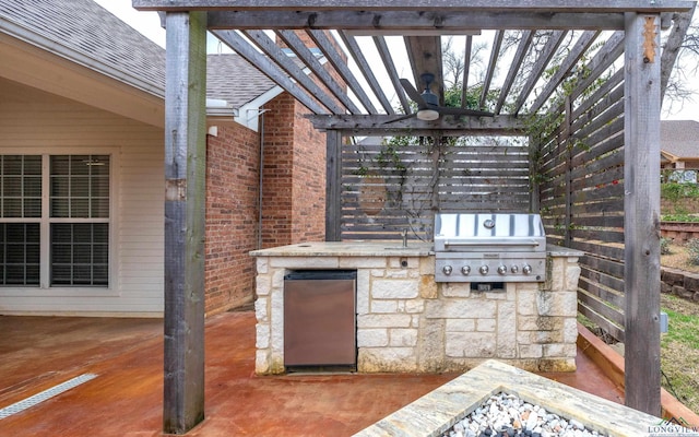 view of patio with exterior kitchen, area for grilling, and a pergola