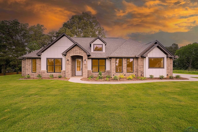 264 Clara Ln, Kilgore, TX 75662 - view of front facade with a yard, brick siding, and board and batten siding