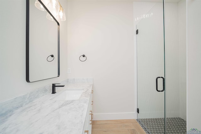 264 Clara Ln, Kilgore, TX 75662 - bathroom featuring a stall shower, vanity, and baseboards