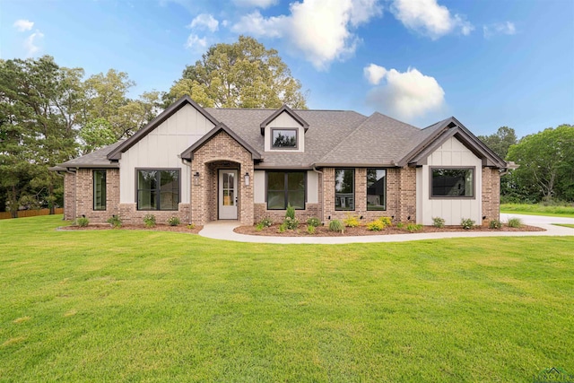 264 Clara Ln, Kilgore, TX 75662 - view of front facade with a front lawn, board and batten siding, and brick siding