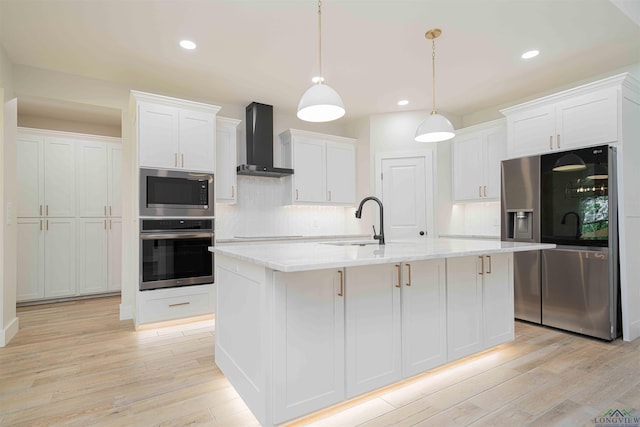 264 Clara Ln, Kilgore, TX 75662 - kitchen featuring wall chimney range hood, appliances with stainless steel finishes, light wood-style flooring, and a sink