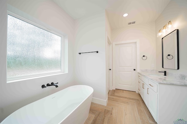 264 Clara Ln, Kilgore, TX 75662 - full bath featuring vanity, baseboards, a soaking tub, and visible vents