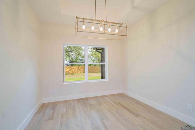 264 Clara Ln, Kilgore, TX 75662 - unfurnished dining area featuring light wood finished floors, an inviting chandelier, and baseboards