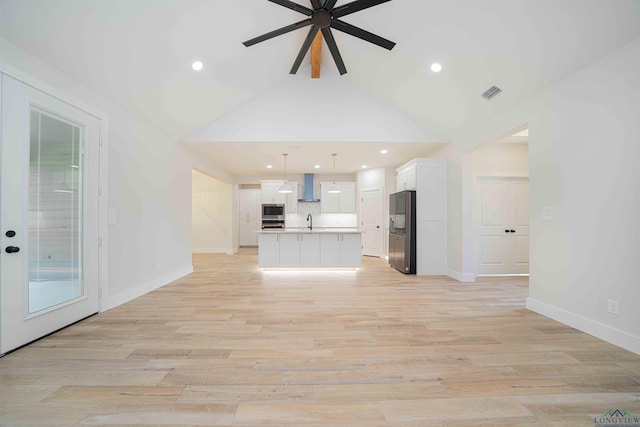 264 Clara Ln, Kilgore, TX 75662 - unfurnished living room featuring a ceiling fan, baseboards, visible vents, a sink, and vaulted ceiling