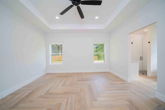 264 Clara Ln, Kilgore, TX 75662 - empty room with baseboards, a raised ceiling, a ceiling fan, and a wealth of natural light