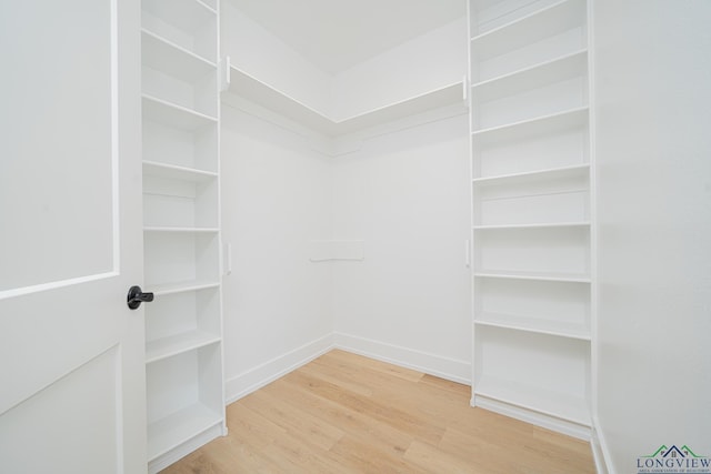 spacious closet featuring hardwood / wood-style floors