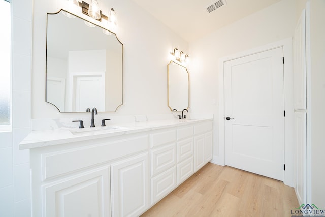 bathroom with vanity and hardwood / wood-style floors