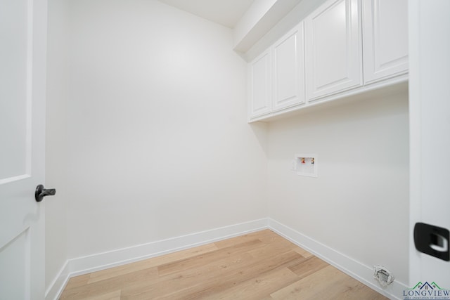 laundry room with cabinets, hookup for a washing machine, and light hardwood / wood-style flooring