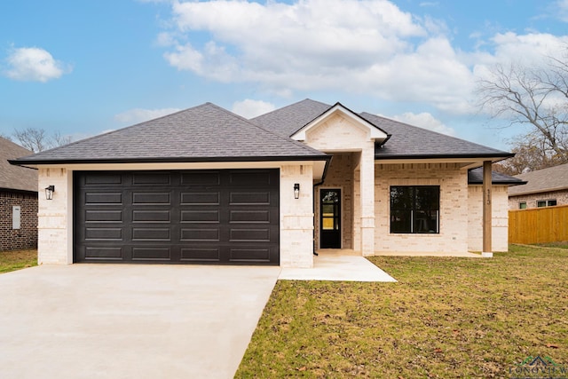 single story home featuring a garage and a front lawn