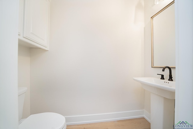 bathroom featuring hardwood / wood-style floors, sink, and toilet