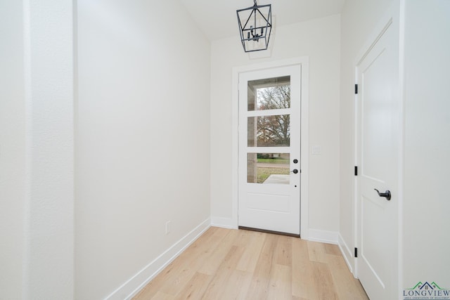 entryway featuring a notable chandelier and light hardwood / wood-style flooring