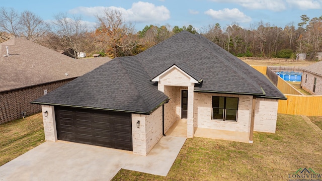 view of front facade with a garage and a front lawn