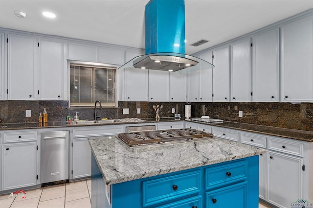 kitchen with sink, a kitchen island, and stone countertops