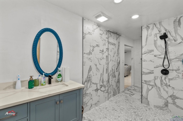 bathroom with a shower and vanity