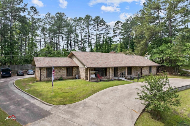 ranch-style home with a porch and a front lawn