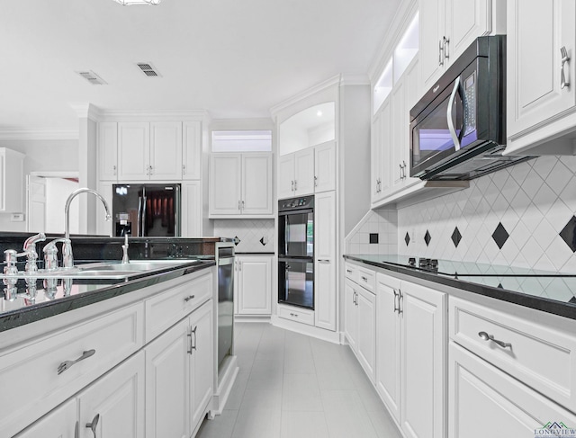 5908 Regents Row, Tyler, TX 75703 - kitchen with black appliances, dark countertops, a sink, white cabinetry, and crown molding