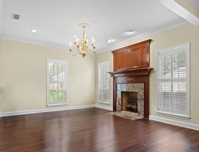 5908 Regents Row, Tyler, TX 75703 - unfurnished living room featuring a chandelier, dark wood-type flooring, a premium fireplace, ornamental molding, and healthy amount of natural light