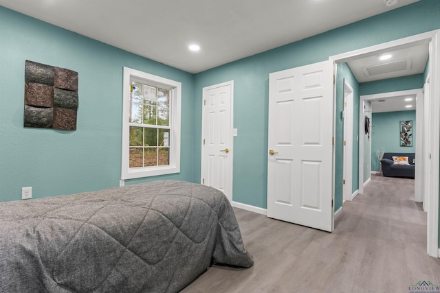 bedroom with attic access, recessed lighting, baseboards, and light wood-type flooring