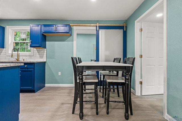 dining area with light wood finished floors and baseboards