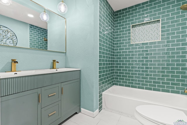 bathroom with tile patterned flooring, toilet, shower / bath combination, a textured wall, and vanity