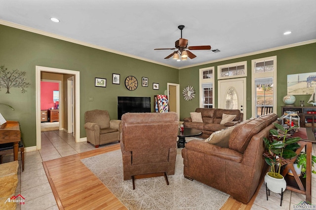 living room featuring ceiling fan, ornamental molding, and light hardwood / wood-style flooring