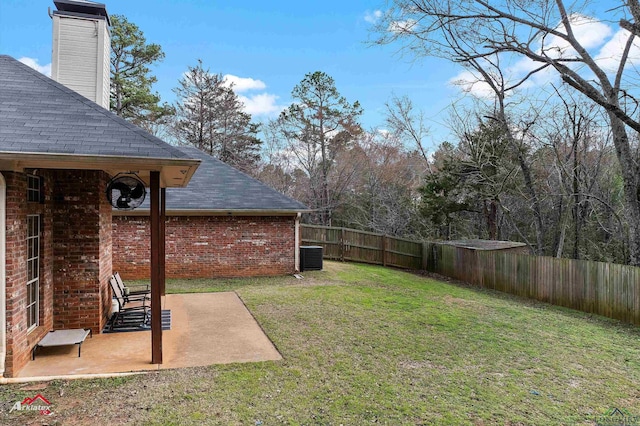 view of yard featuring central AC unit and a patio area