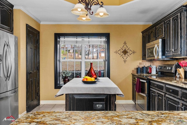 kitchen featuring light tile patterned flooring, a kitchen island, appliances with stainless steel finishes, pendant lighting, and crown molding