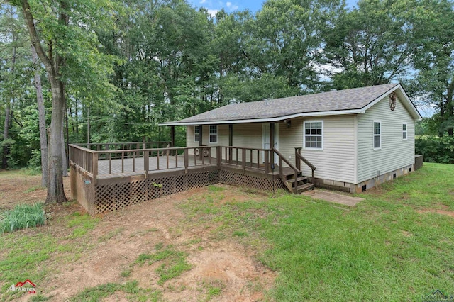4501 Fm 1650, Gilmer, TX 75645 - view of front of property featuring roof with shingles, a wooden deck, a front yard, and view of wooded area