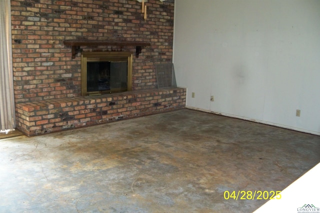 unfurnished living room with concrete flooring and a fireplace