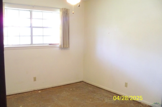 unfurnished room featuring baseboards and a healthy amount of sunlight