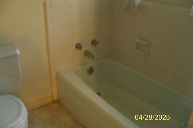 full bath featuring baseboards, toilet, and tile patterned flooring