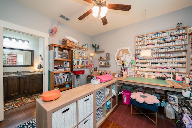 office space featuring dark hardwood / wood-style floors, ceiling fan, and sink