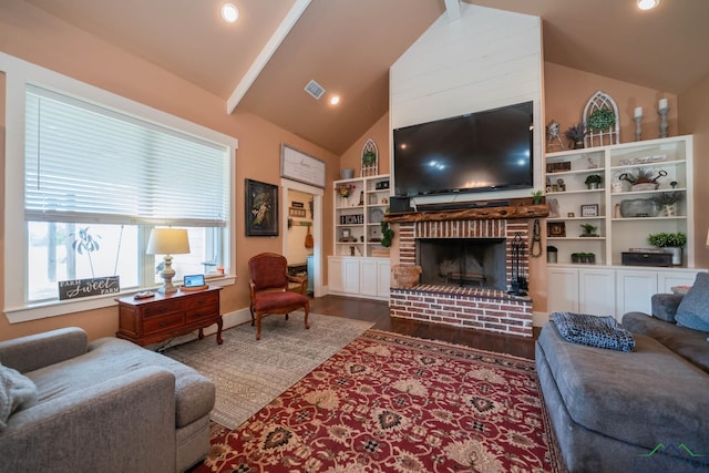 living room with a fireplace, vaulted ceiling, and hardwood / wood-style flooring