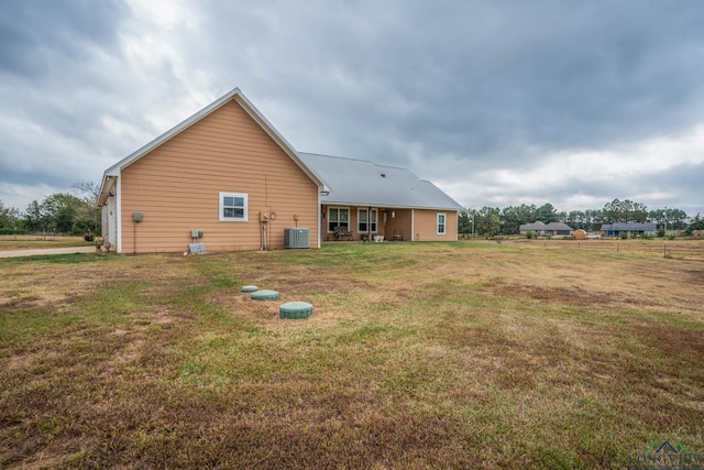 rear view of property with a yard