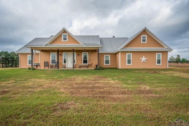 back of property with a lawn and a patio area