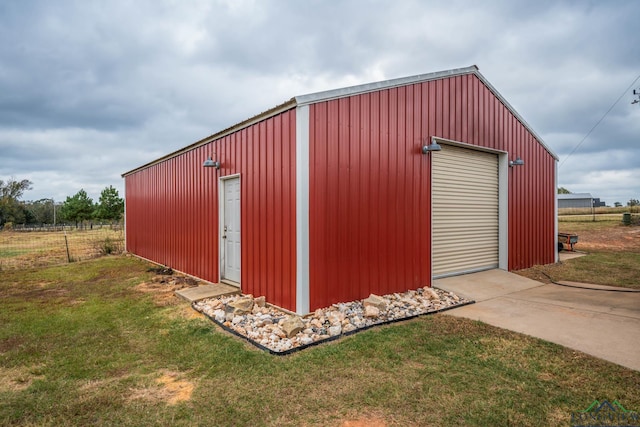 view of outdoor structure featuring a yard and a garage