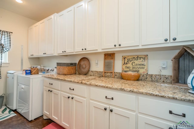 washroom featuring washer and clothes dryer and cabinets