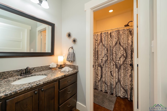 bathroom with a shower with shower curtain and vanity